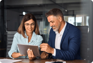 Two colleagues looking at a tablet